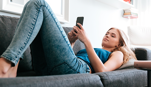 Young woman focusing on her mobile phone