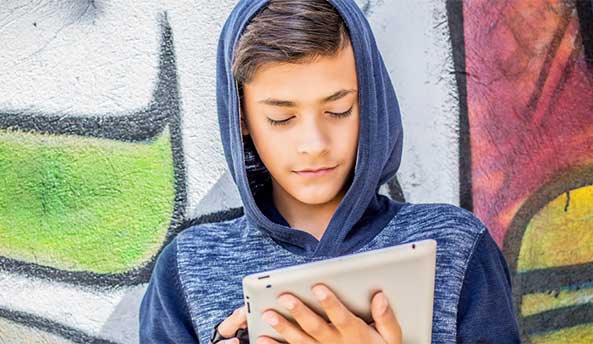 Young boy focusing on his iPad